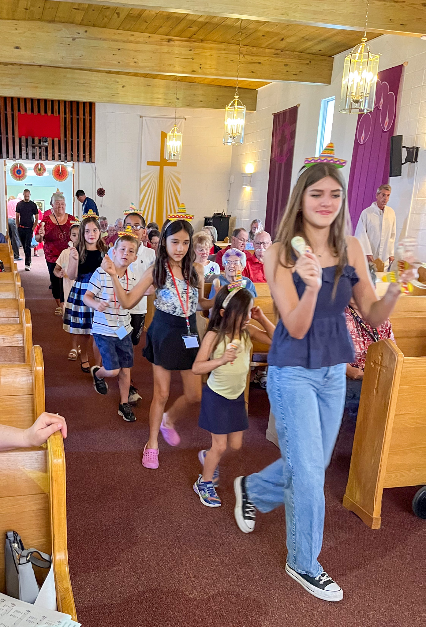 Youth Minister leading children through worship